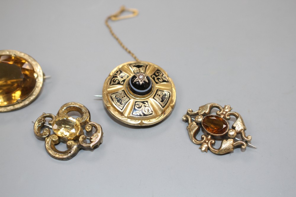 A Victorian yellow metal, enamel, banded agate and seed pearl set mourning brooch and three other brooches,